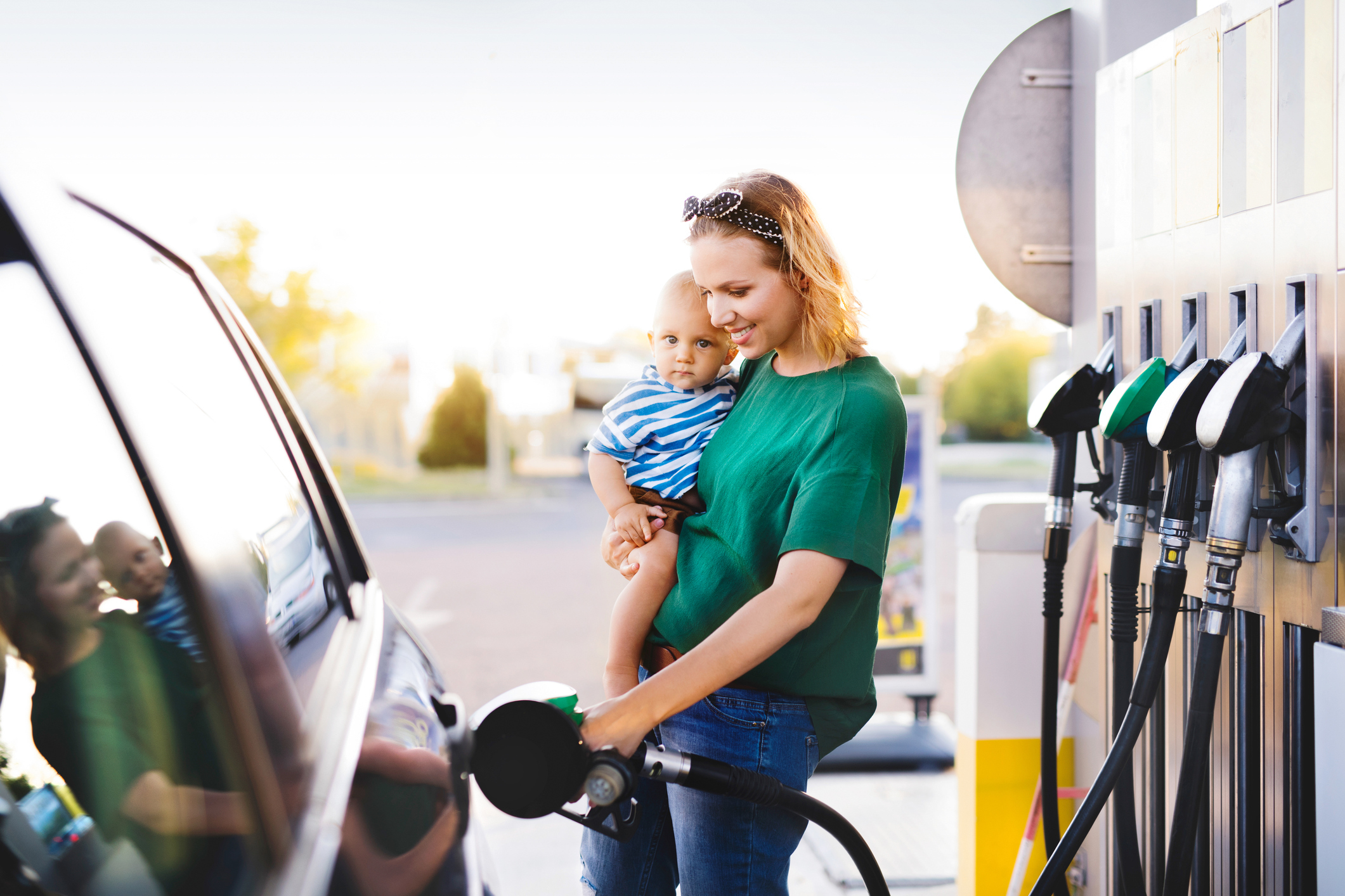 Woman pumping gas at a convenience store